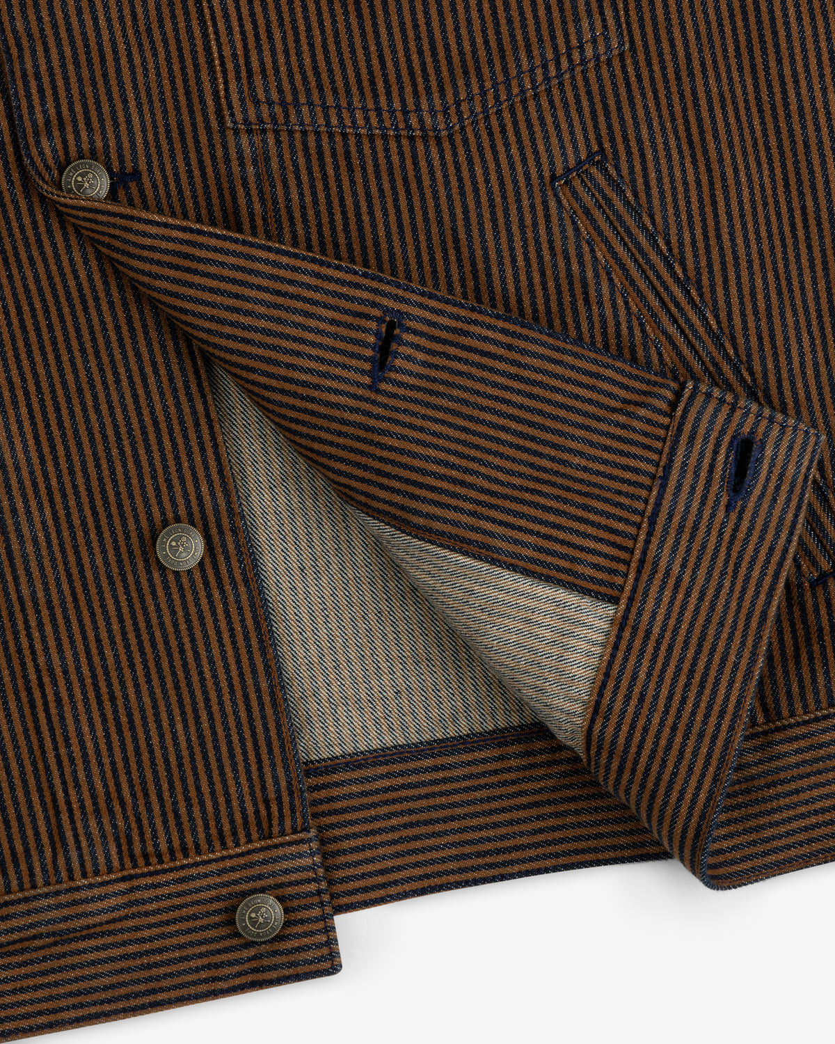 Hickory Stripe Denim Trucker Jacket with brown and navy stripes, shown partially open to display its inner lining.