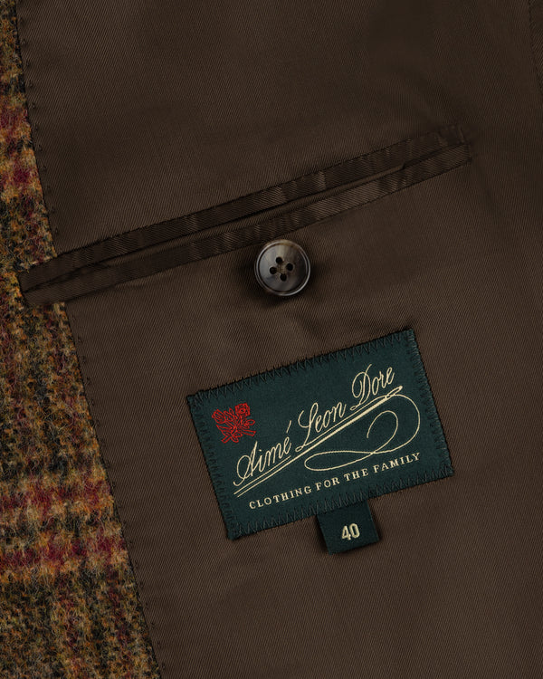 Interior of a Single-Breasted Plaid Tweed Suit Jacket with a brown lining, welt pocket, button, and size 40 brand label.