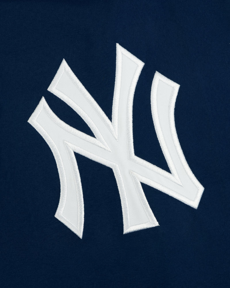 Yankees GORE-TEX Rain Delay Jacket featuring a white NY logo on dark blue, inspired by the iconic baseball team.