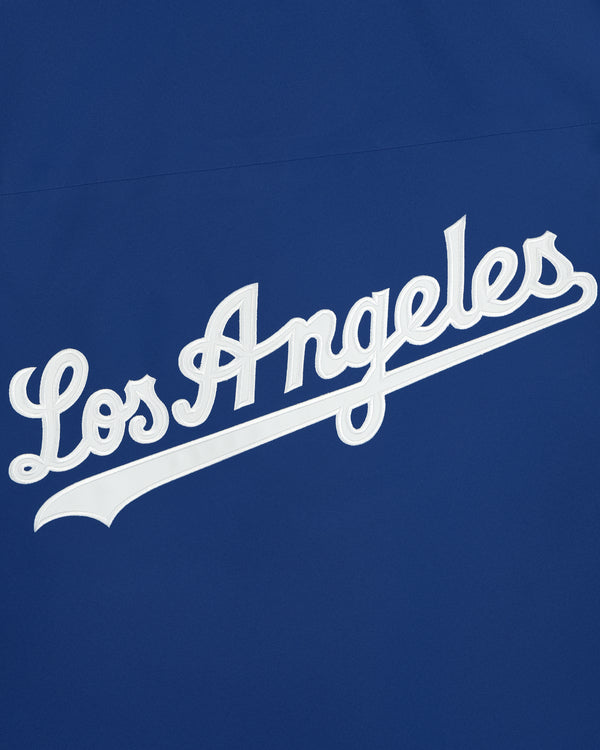 Dodgers GORE-TEX Rain Delay Jacket with white “Los Angeles” script on royal blue, classic sports team logo style.