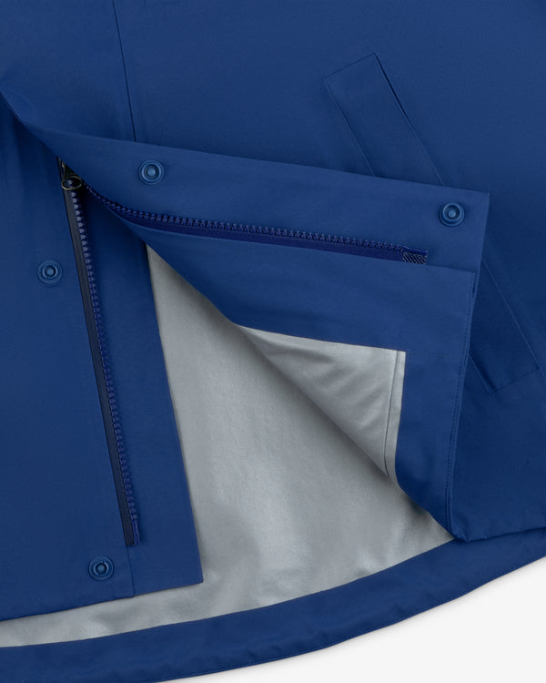 Close-up of Dodgers GORE-TEX Rain Delay Jacket with blue fabric, open zipper, snaps, pocket, and gray lining inside.
