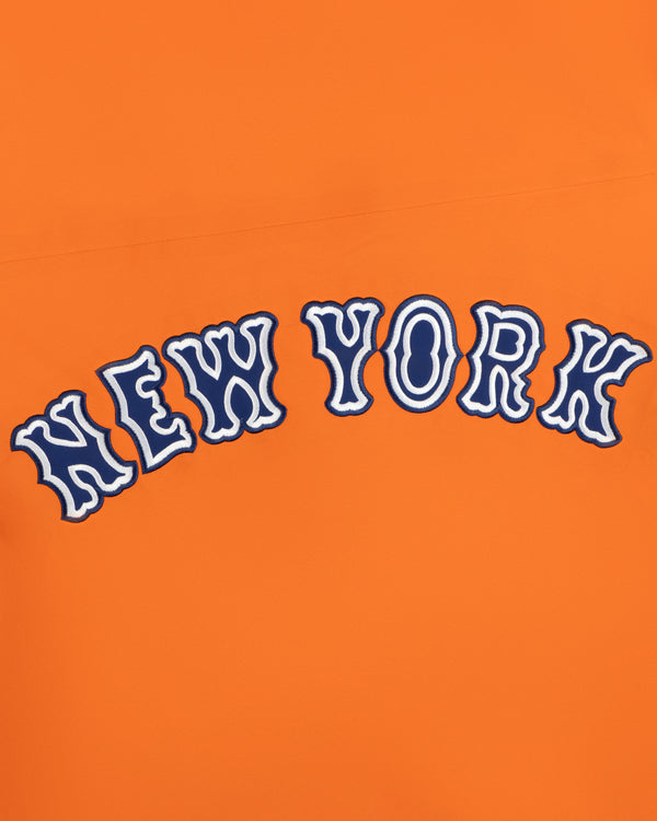 The words NEW YORK in wavy blue and white letters on Mets GORE-TEX Rain Delay Jacket’s bright orange background.