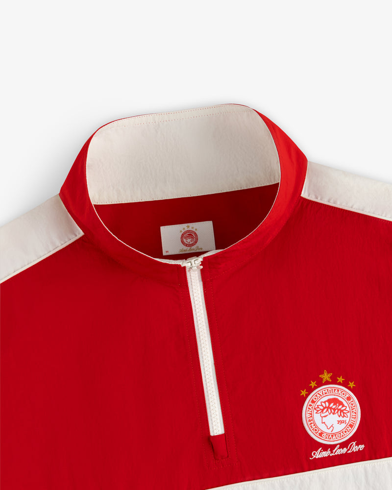 Red and white ALD / Olympiacos F.C. Nylon Quarter Zip Pullover with a team crest and text on the chest.
