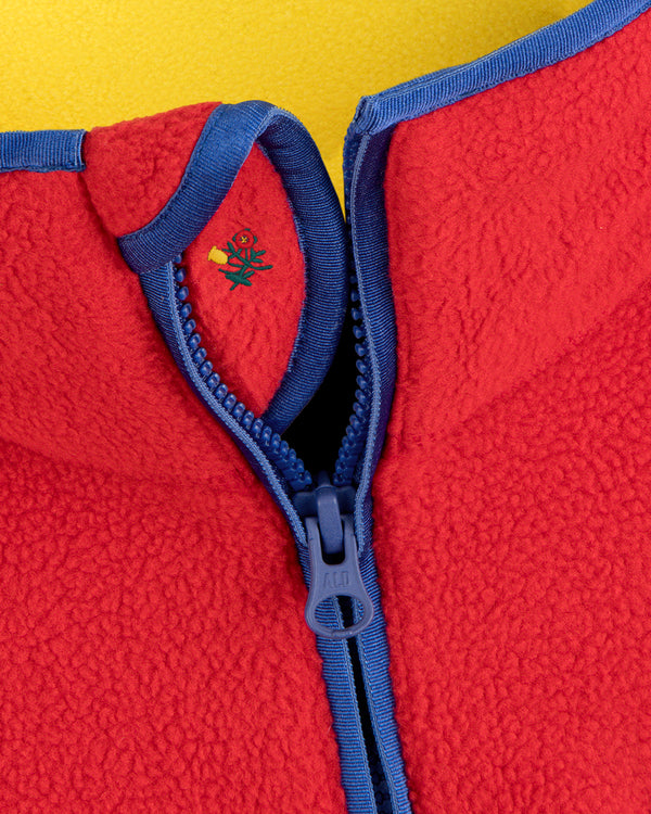 Script Fleece Half Zip Pullover in red with blue trim, a blue zipper, and an embroidered flower logo on the inner collar.