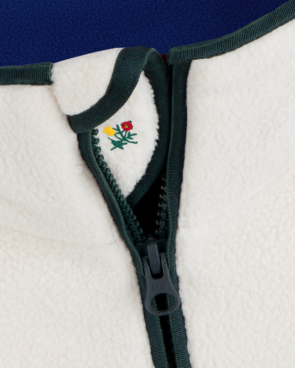Cream-colored Script Fleece Half Zip Pullover with dark green trim and small floral embroidery near the collar.