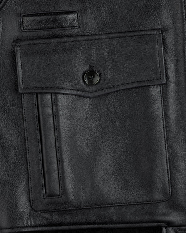 Close-up of a Napa Leather Bomber Jacket pocket with a flap, button closure, and vertical welt detail.
