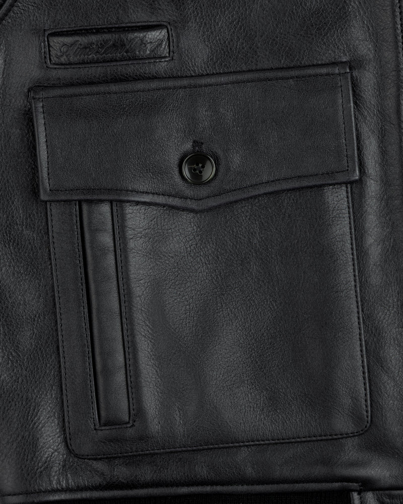 Close-up of a Napa Leather Bomber Jacket pocket with a flap, button closure, and vertical welt detail.