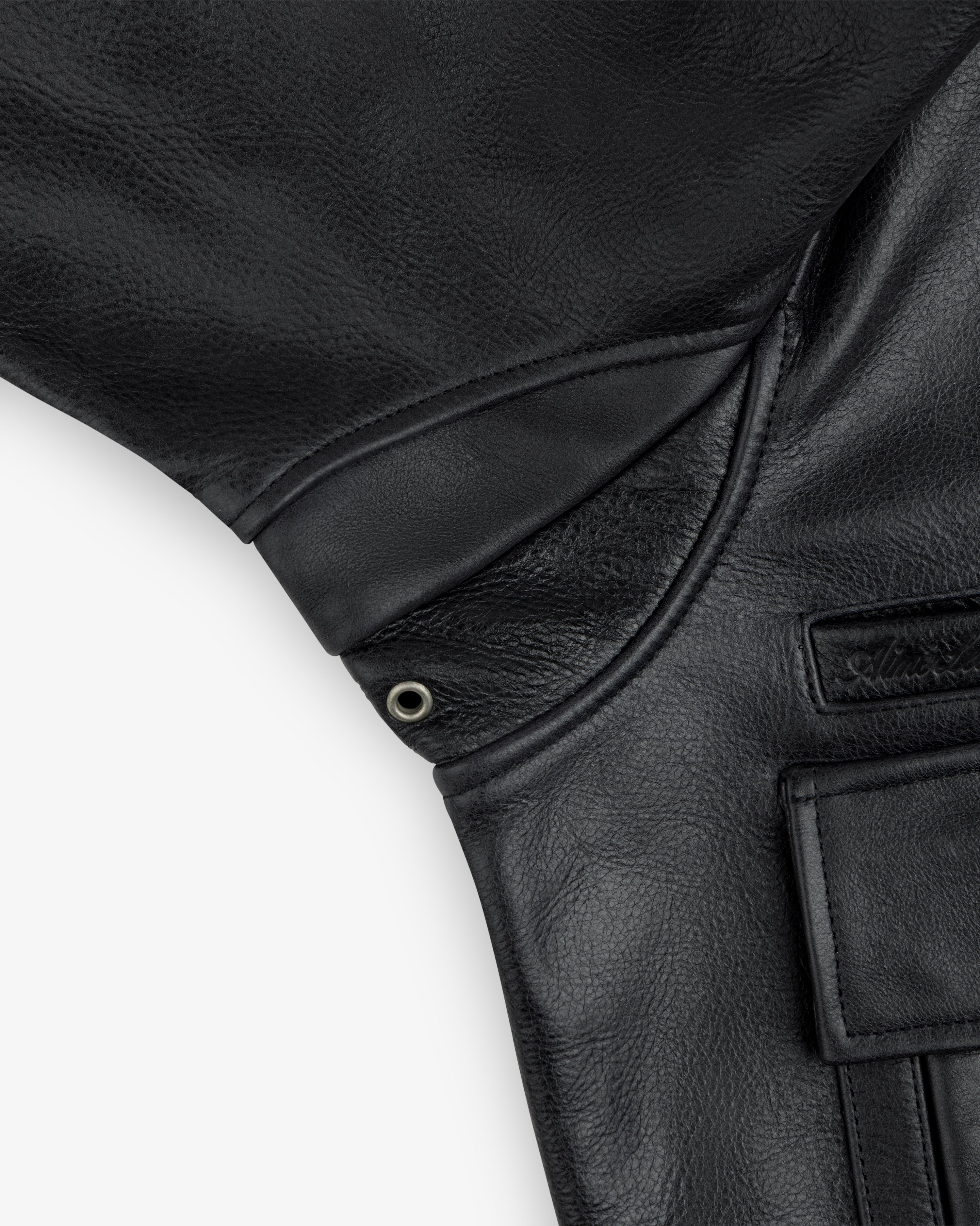 Close-up of a Napa Leather Bomber Jacket underarm featuring a metal grommet vent and a small pocket.