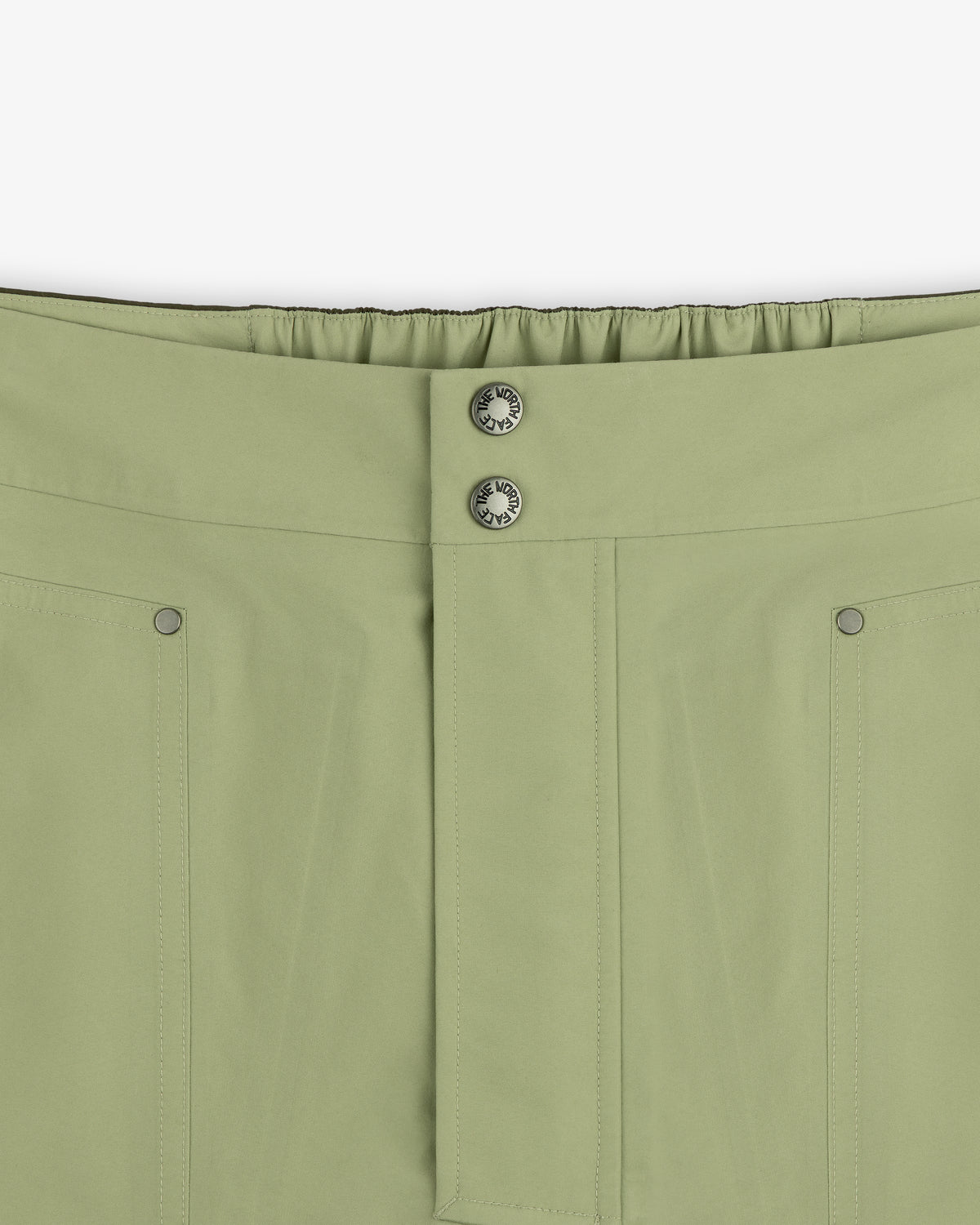 Close-up of ALD/The North Face GORE-TEX Pant featuring front seam, two metal buttons, and elastic waistband at back.