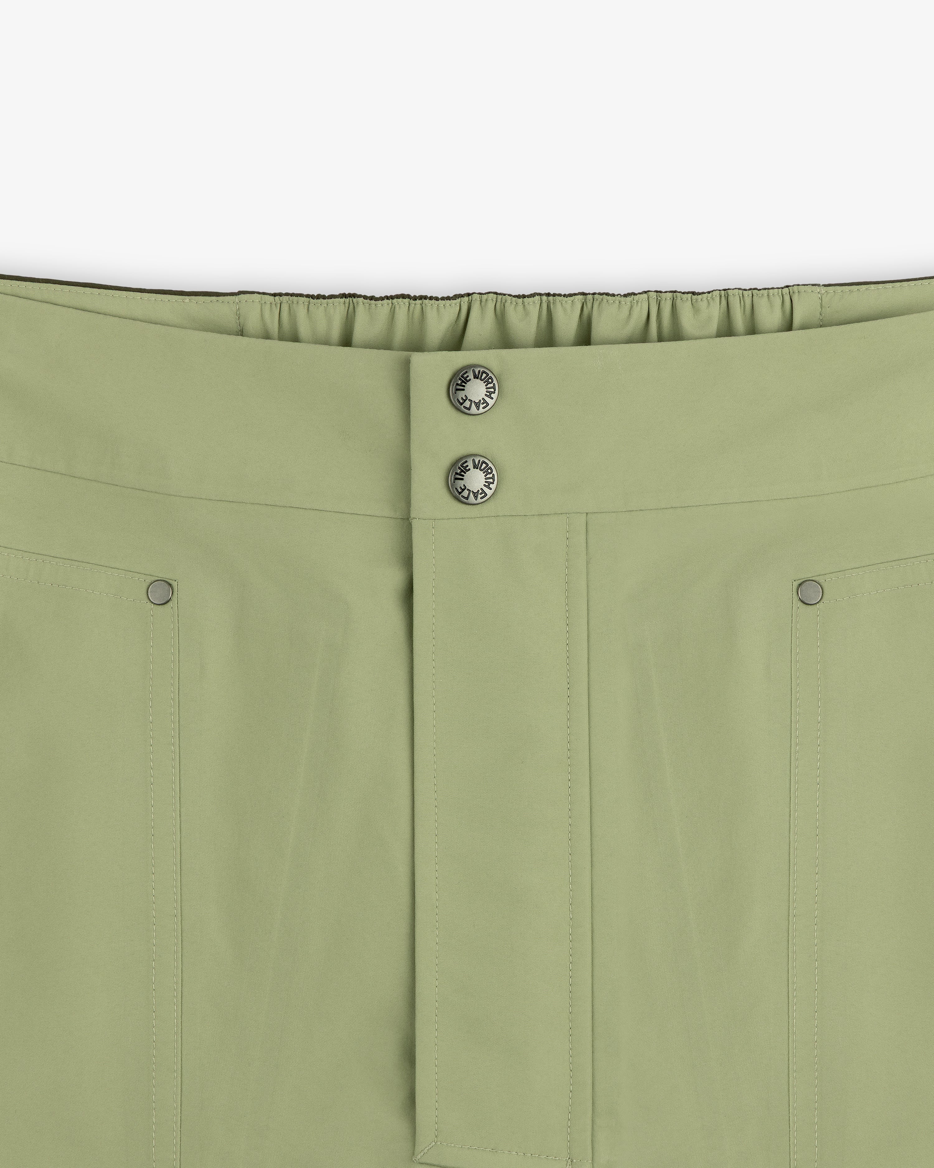 Close-up of ALD/The North Face GORE-TEX Pant featuring front seam, two metal buttons, and elastic waistband at back.