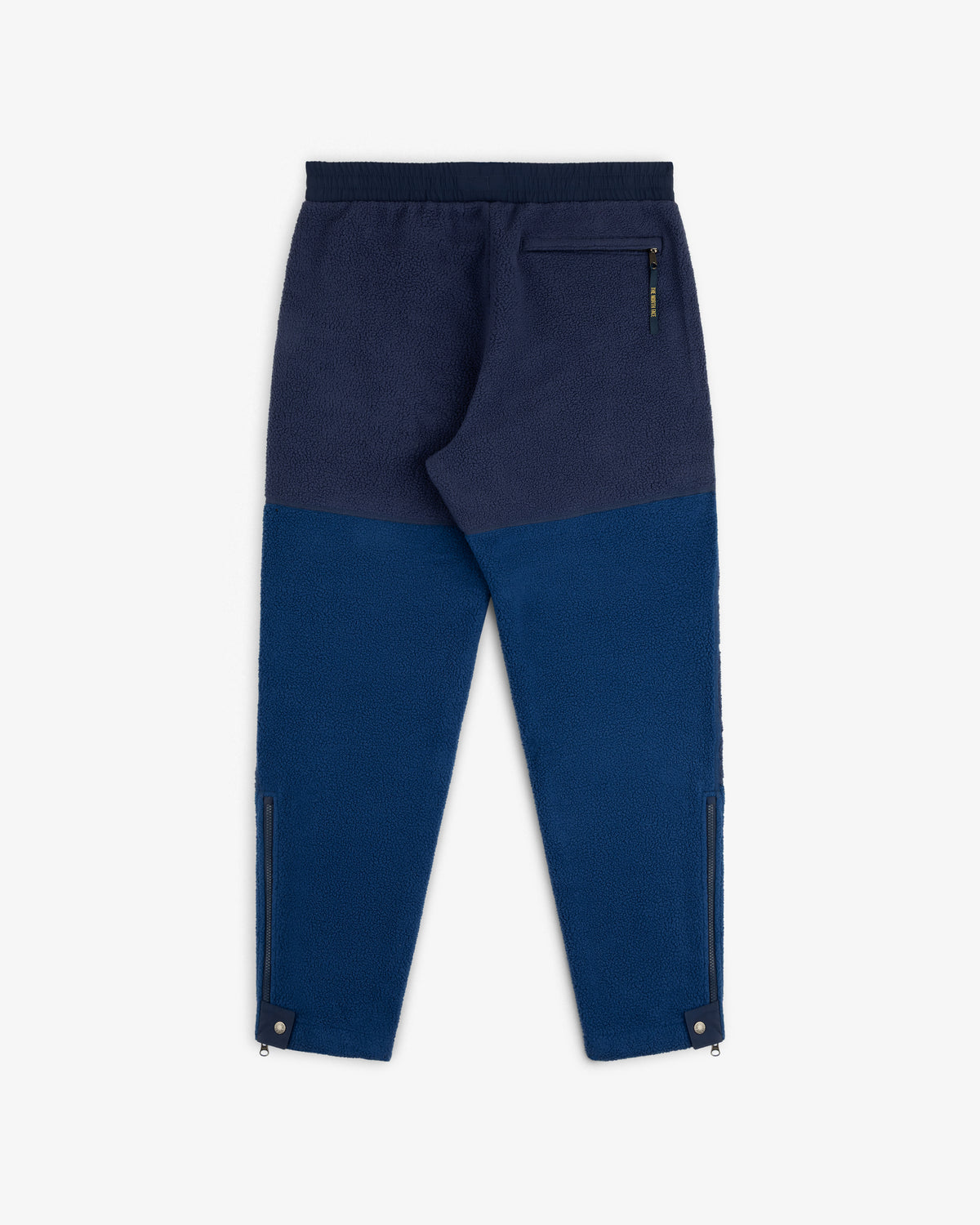 ALD / The North Face Denali Fleece Pant in blue with black waistband, back zip pocket, and zippered leg openings.