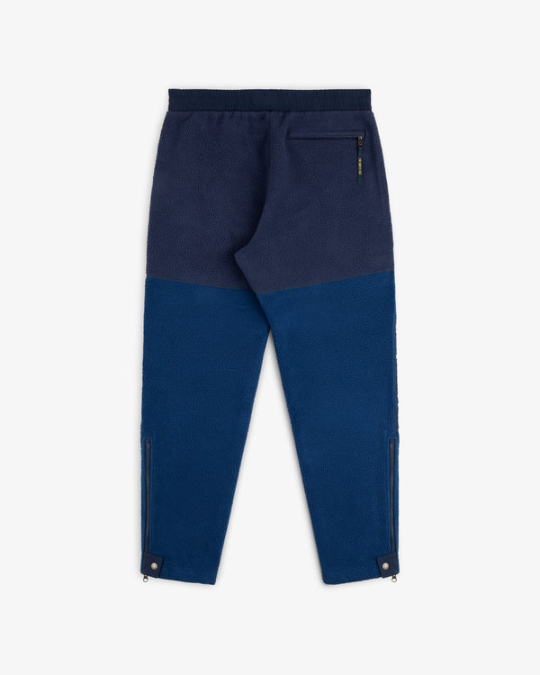 ALD / The North Face Denali Fleece Pant in blue with black waistband, back zip pocket, and zippered leg openings.