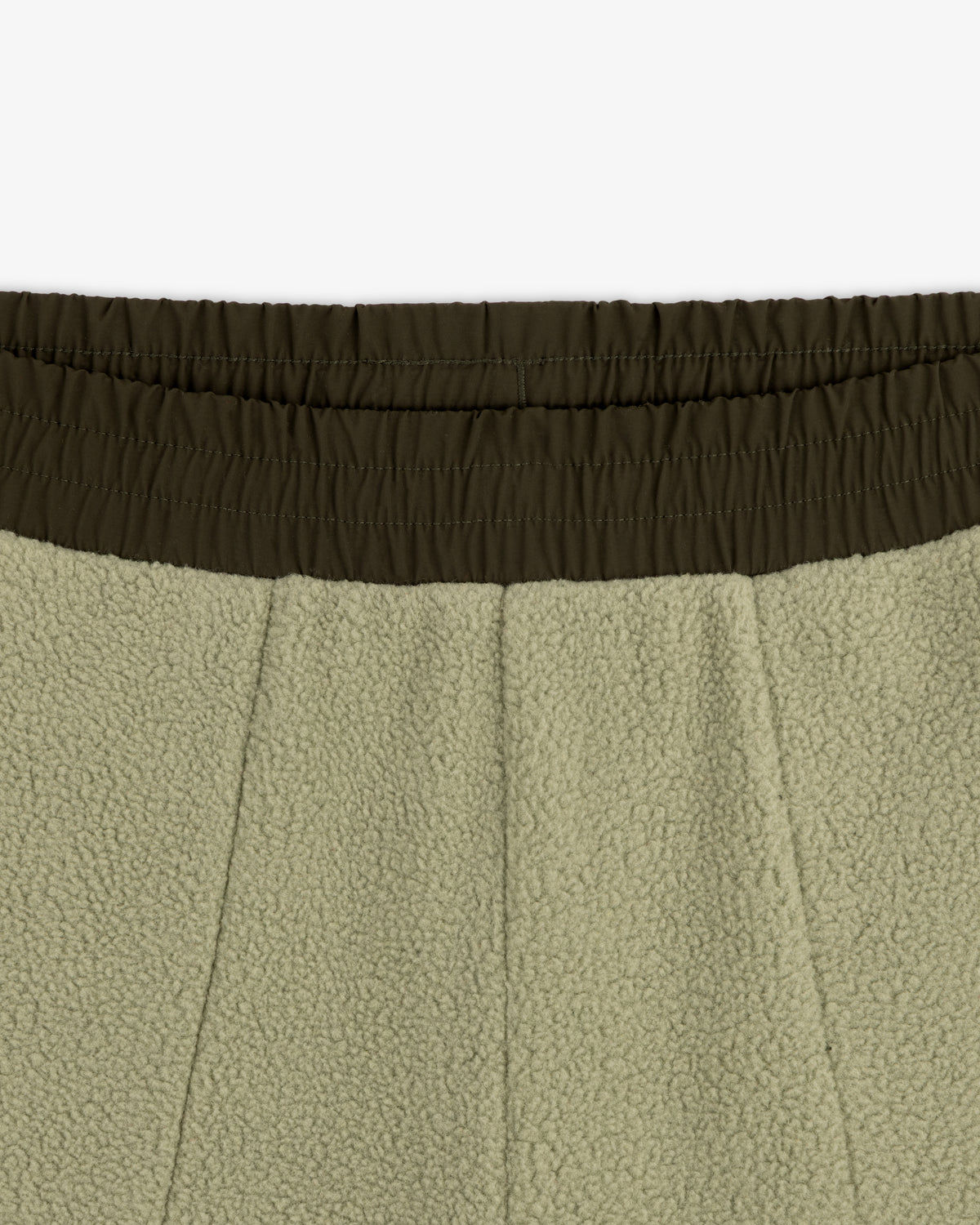 Close-up of the elastic waistband and upper section of olive green ALD / The North Face Denali Fleece Pant.