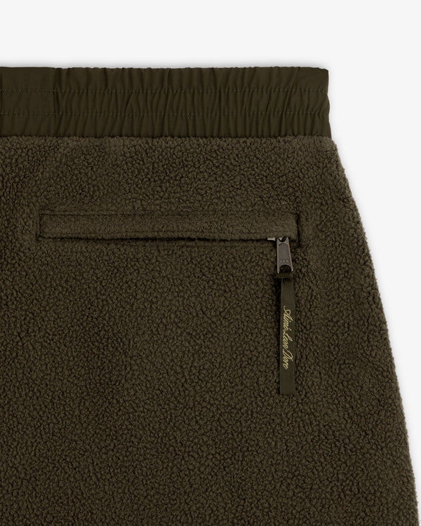 Close-up of ALD / The North Face Denali Fleece Pant in olive green, highlighting zip pocket, elastic waist, and texture.