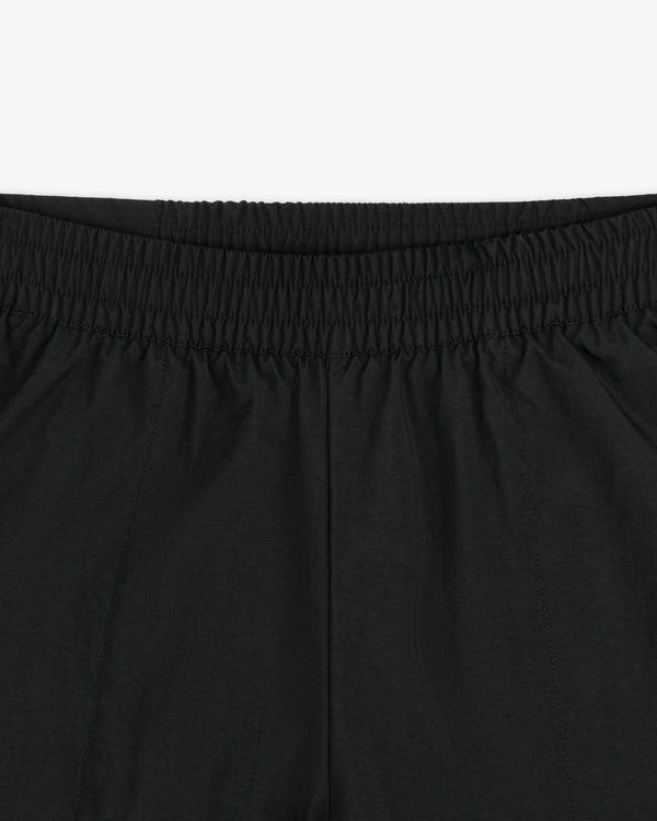 Close-up of the elastic waistband and upper section of ALD / The North Face Nylon Denali Pant in black.