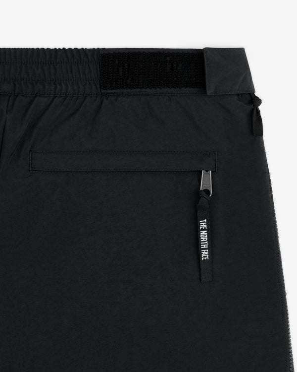 Close-up of ALD / The North Face Nylon Denali Pant with a zippered back pocket and branded zipper pull.