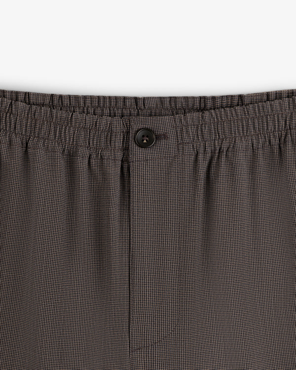 Close-up of Houndstooth Elasticated Waist Trouser with black button and comfy waistband.