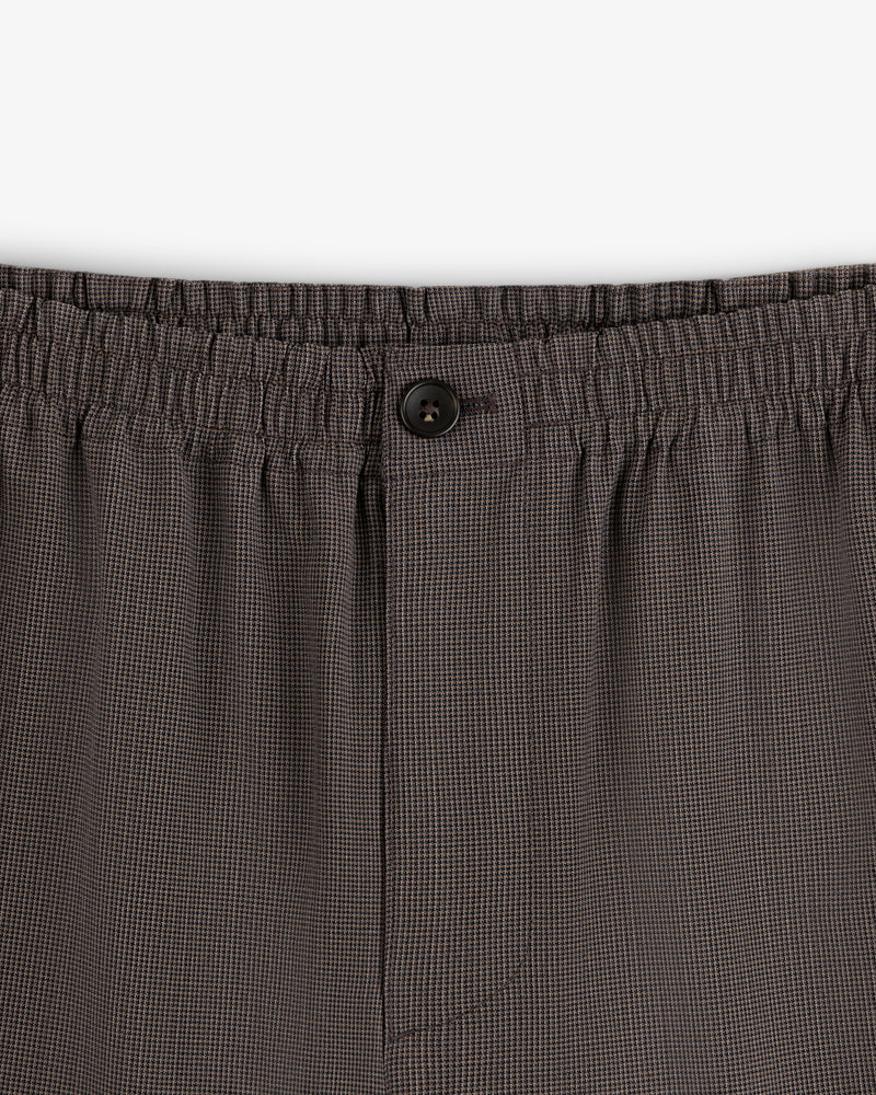 Close-up of Houndstooth Elasticated Waist Trouser with black button and comfy waistband.