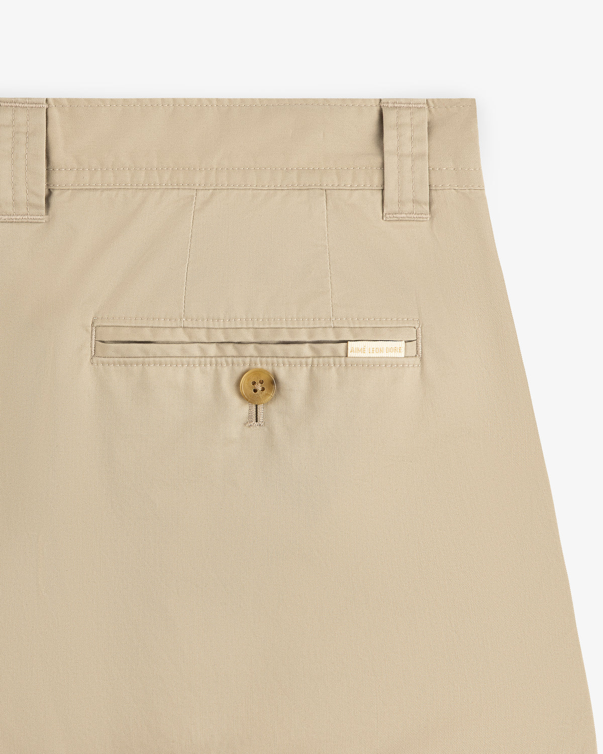 Double Pleated Officer Pant in beige with belt loops, buttoned back pocket, and a label above the pocket.
