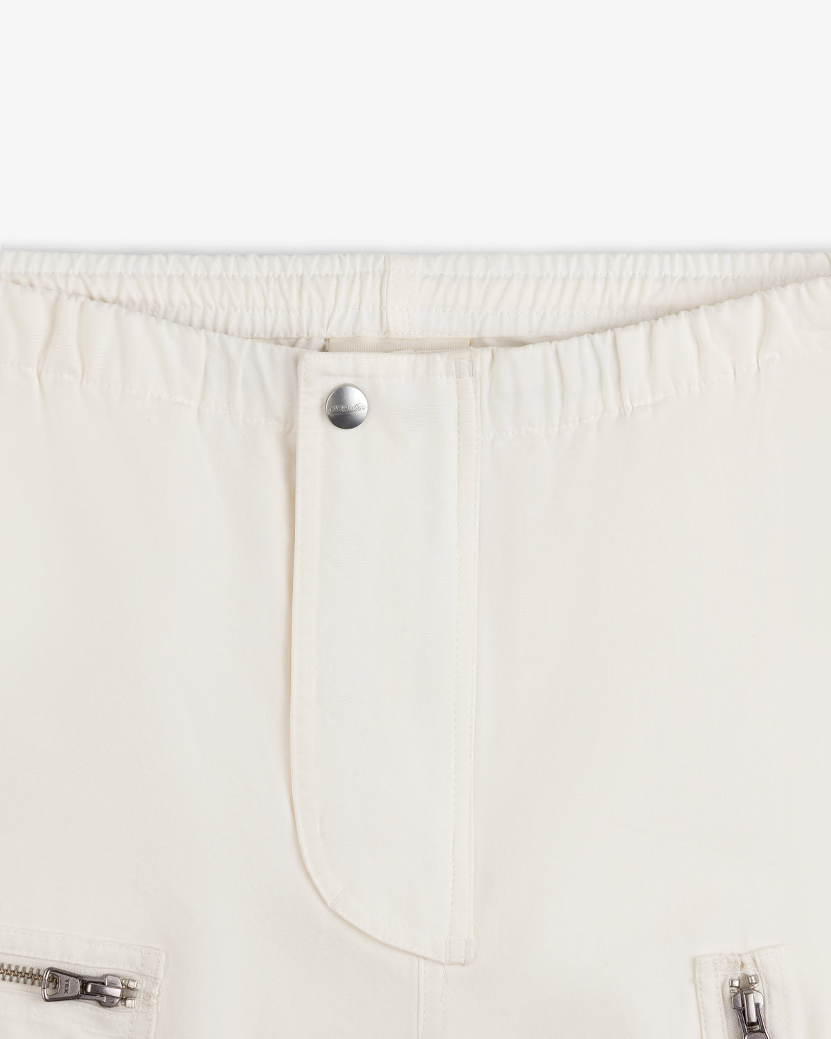 Garment Washed Aviator Pants in off-white with an elastic waistband, single silver button, and zippered pockets.