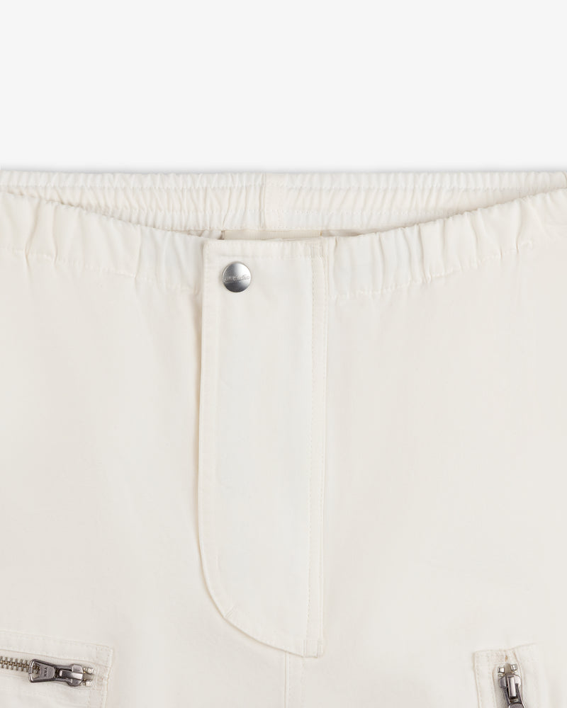 Garment Washed Aviator Pants in off-white with an elastic waistband, single silver button, and zippered pockets.