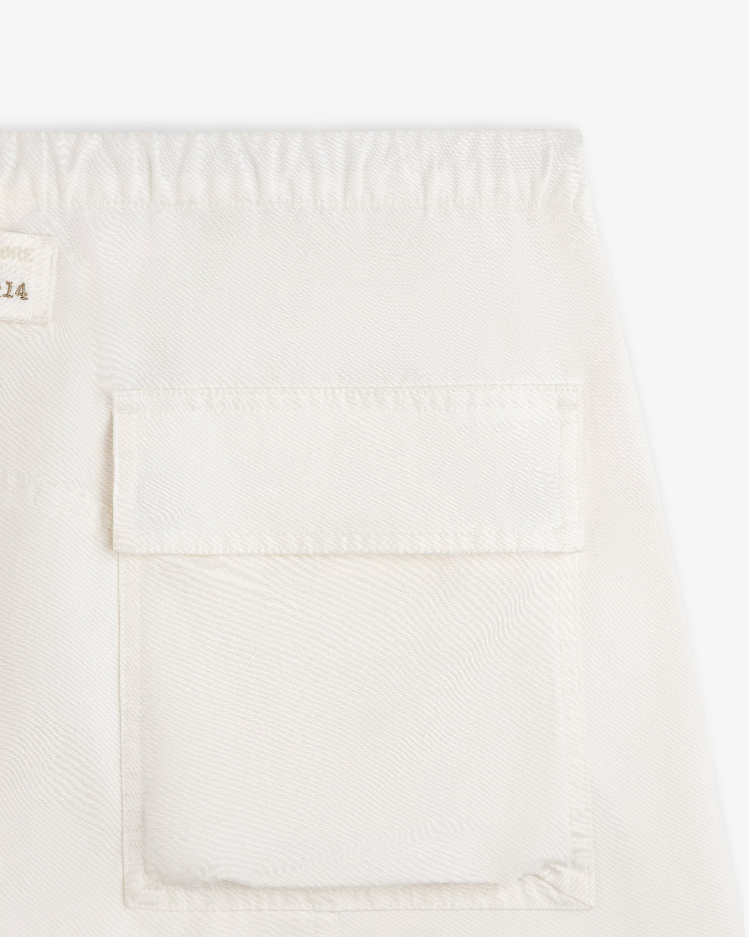 Garment Washed Aviator Pants in off-white with an elastic waistband and a large patch pocket on the leg.