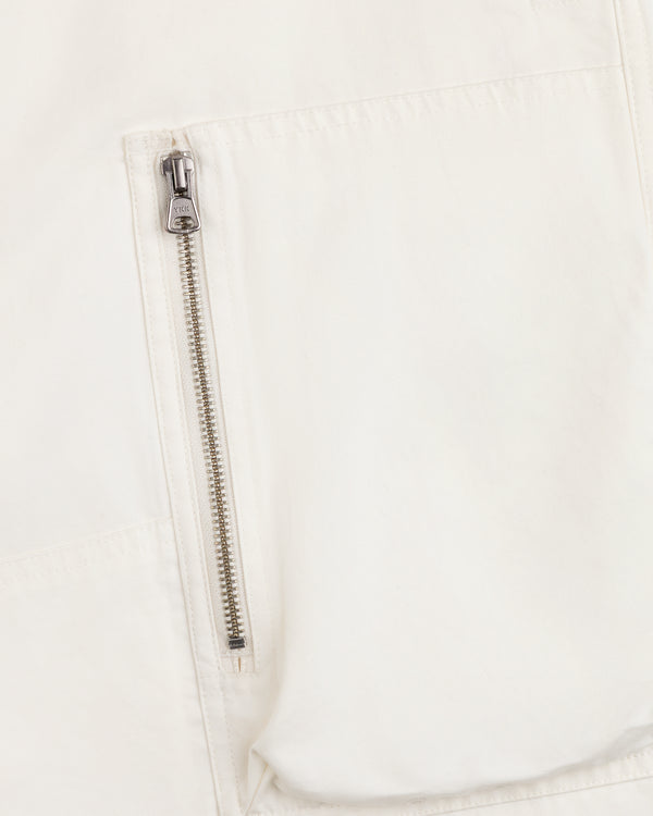 Close-up of a vertical metal zipper pocket on the off-white fabric of the Garment Washed Aviator Pant.