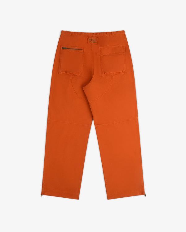 Back view of orange Garment Washed Aviator Pant featuring two back pockets, one zippered, and zippered ankle cuffs.