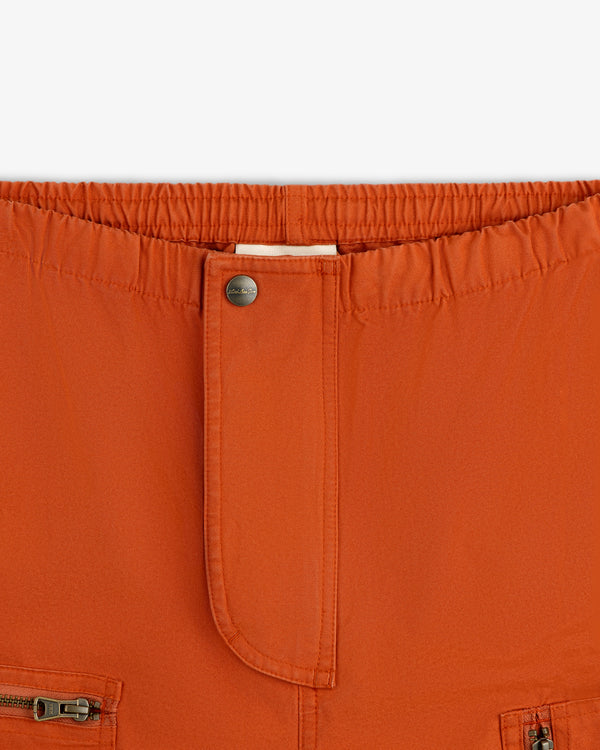 Garment Washed Aviator Pants in rust with an elastic waistband, a single metal button, and front zipper pockets.