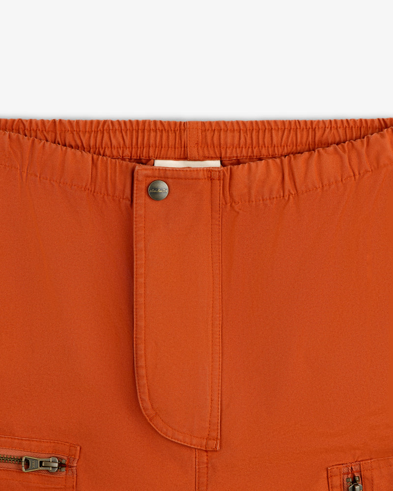 Garment Washed Aviator Pants in rust with an elastic waistband, a single metal button, and front zipper pockets.