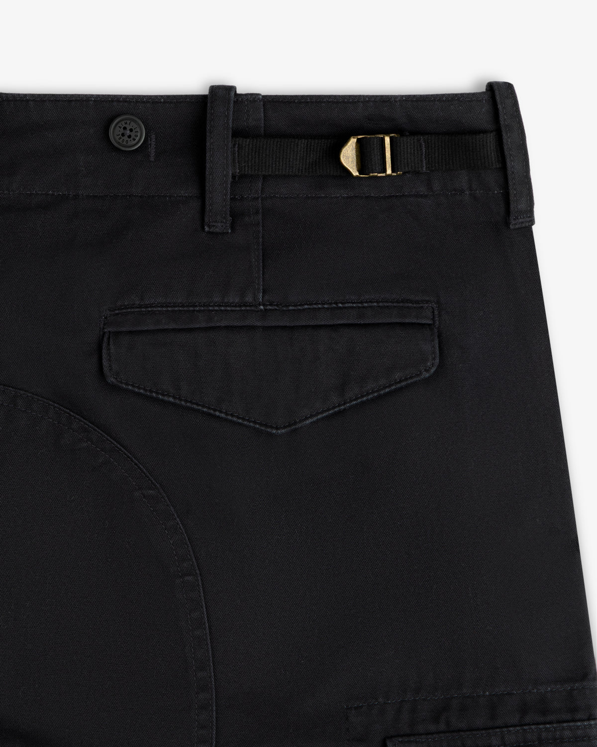 Close-up of Fatigue Pant: black with belt loop, button, gold buckle strap, and flap back pocket.
