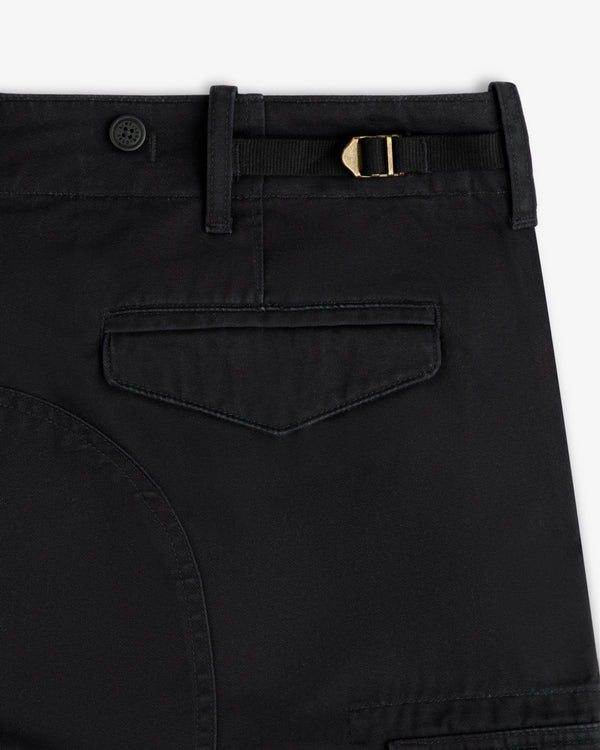 Close-up of Fatigue Pant: black with belt loop, button, gold buckle strap, and flap back pocket.