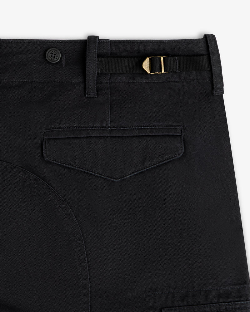 Close-up of Fatigue Pant: black with belt loop, button, gold buckle strap, and flap back pocket.