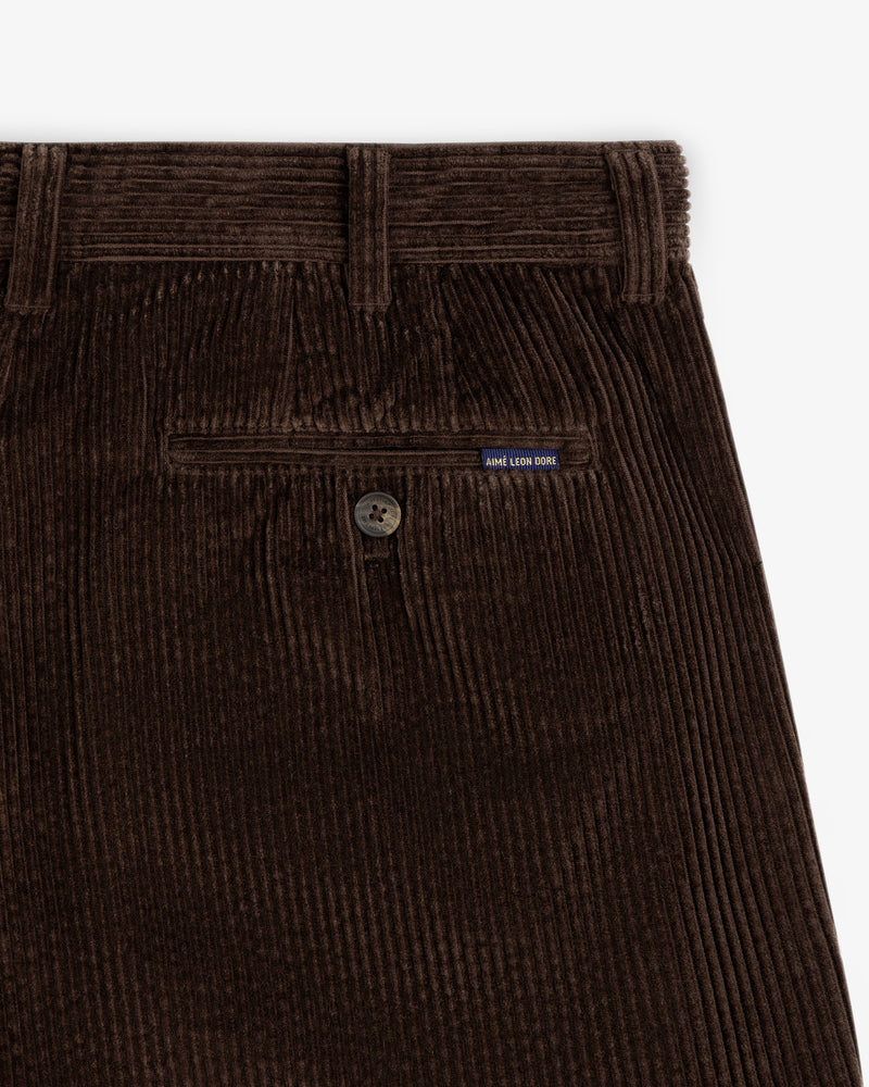 Dark brown Corduroy Trouser featuring a buttoned back pocket with a small brand tag.