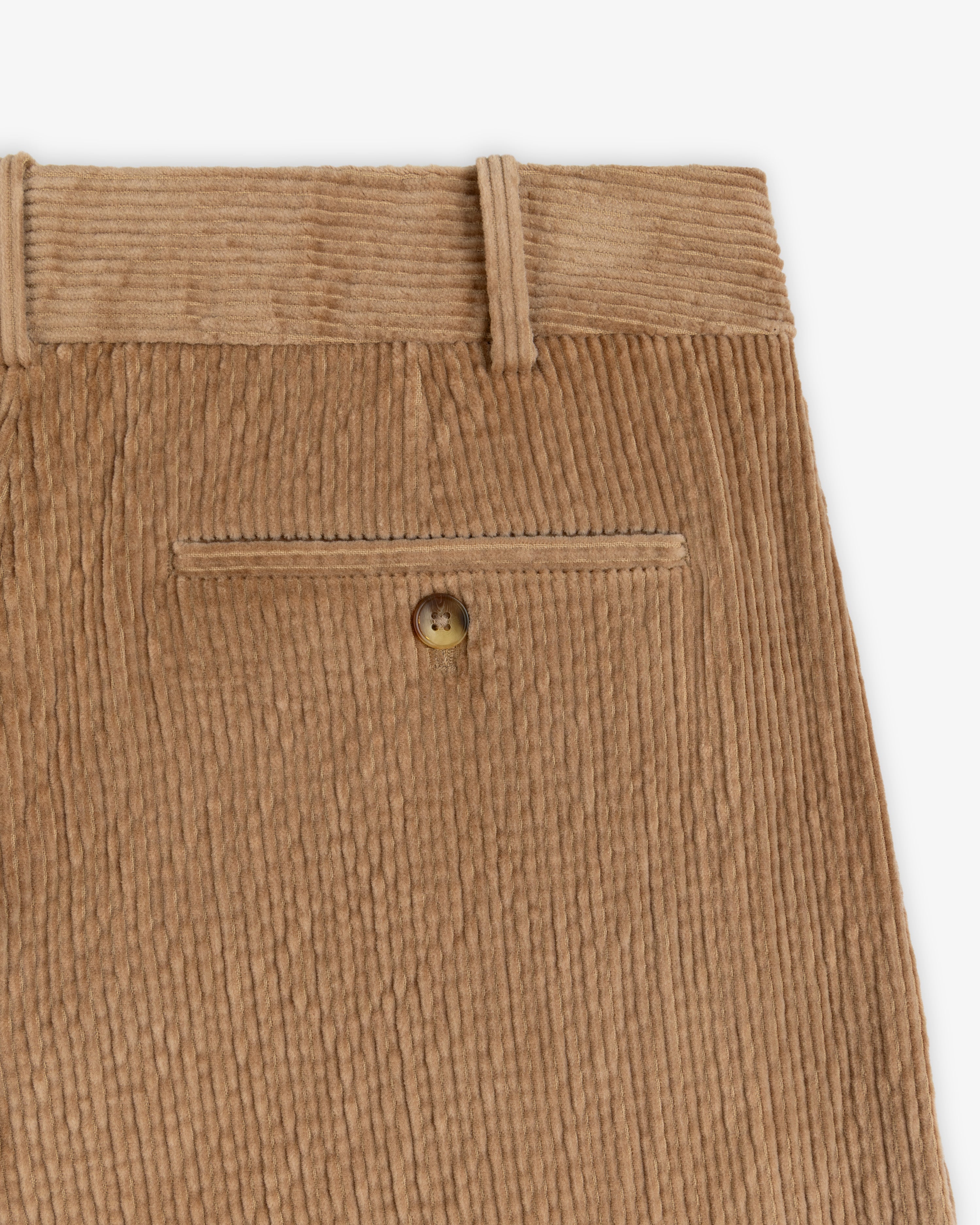 Double Pleated Corduroy Trouser in tan with a buttoned back welt pocket and belt loops.