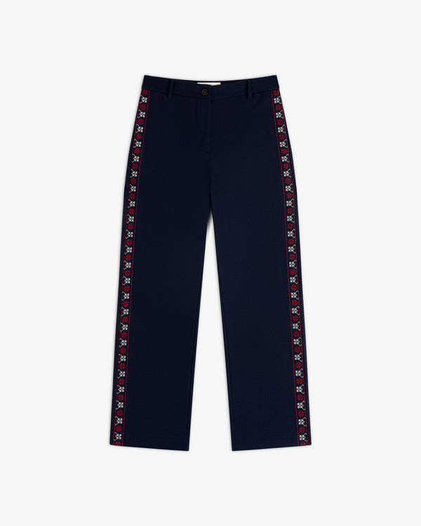 Mani Embroidered Wool Pant in navy blue with a decorative red and white embroidered stripe down each side.
