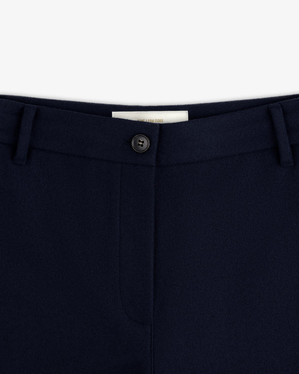 Mani Embroidered Wool Pant in navy, featuring a button closure, belt loops, and an interior brand label.