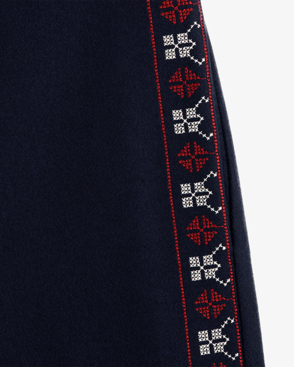 Mani Embroidered Wool Pant in dark wool with a vertical strip of red and white geometric embroidery.