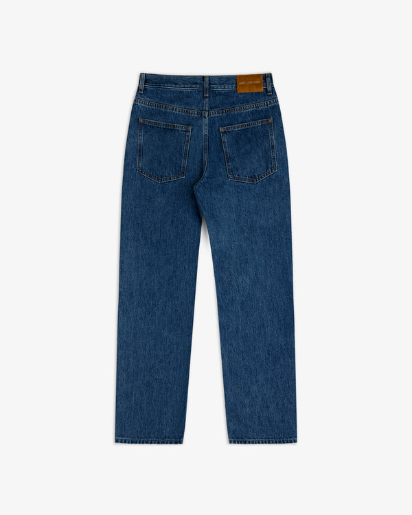 Back view of ALD Relaxed Fit Denim in dark wash blue, featuring two back pockets and a leather logo patch on the waistband.