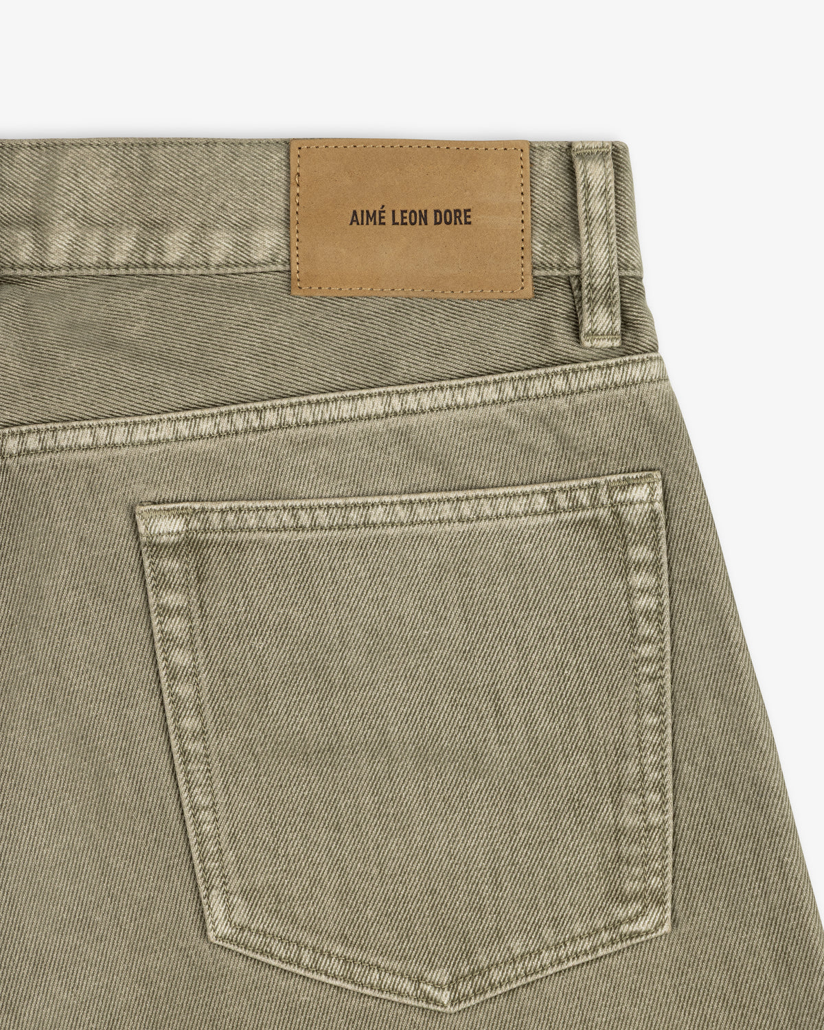 Flocked Straight Fit Denim jeans in olive green with a back pocket and tan brand-labeled leather patch.