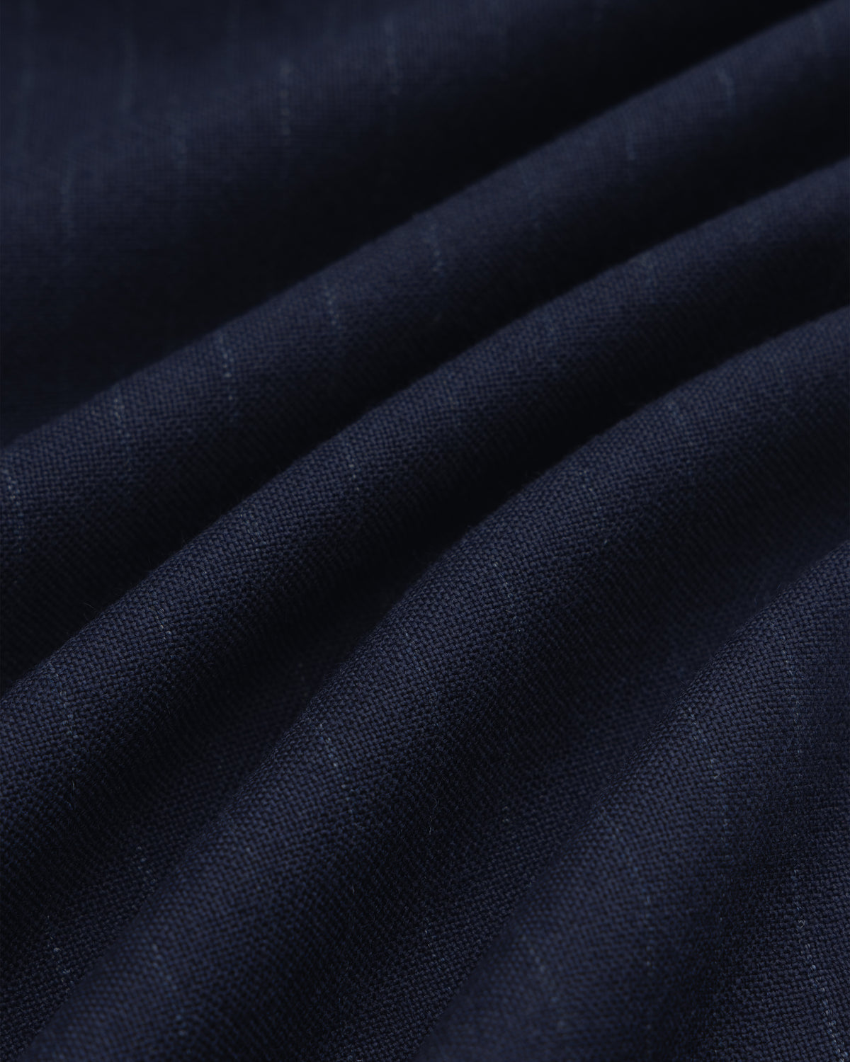 Dark blue Wool Chalk Stripe Elasticated Waist Trouser fabric with subtle vertical chalk stripes, shown in soft folds.