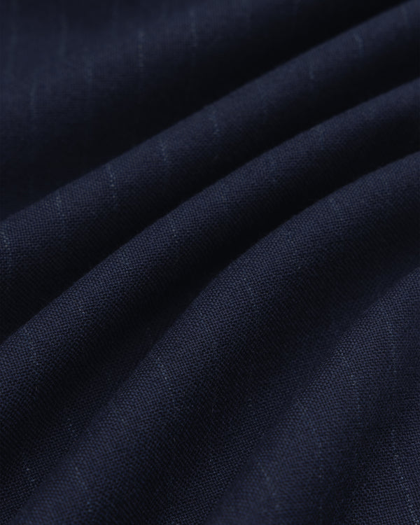 Dark blue Wool Chalk Stripe Elasticated Waist Trouser fabric with subtle vertical chalk stripes, shown in soft folds.