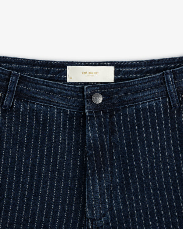 Close-up of Chalk Stripe Painter Pant in dark blue with a button, belt loops, and a white waistband label.
