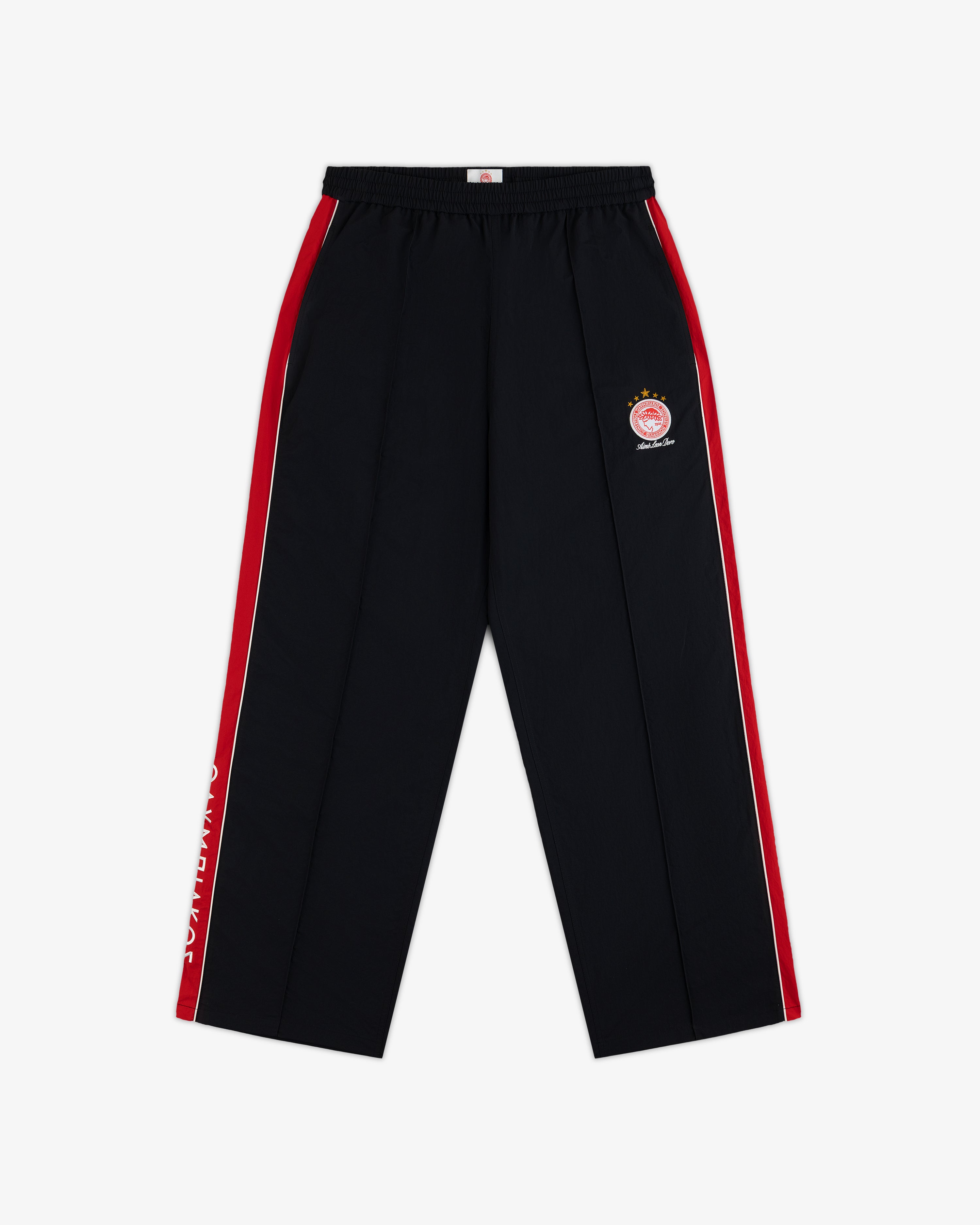 ALD / Olympiacos F.C. Nylon Track Pant in black with red and white side stripes and a soccer team crest on the hip.