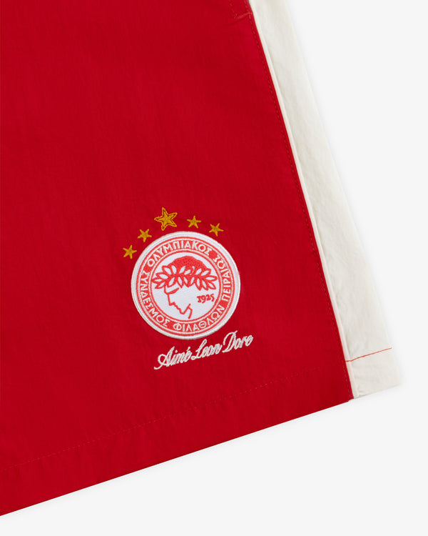 ALD / Olympiacos F.C. Nylon Training Short in red nylon with a white side panel and an embroidered team crest.
