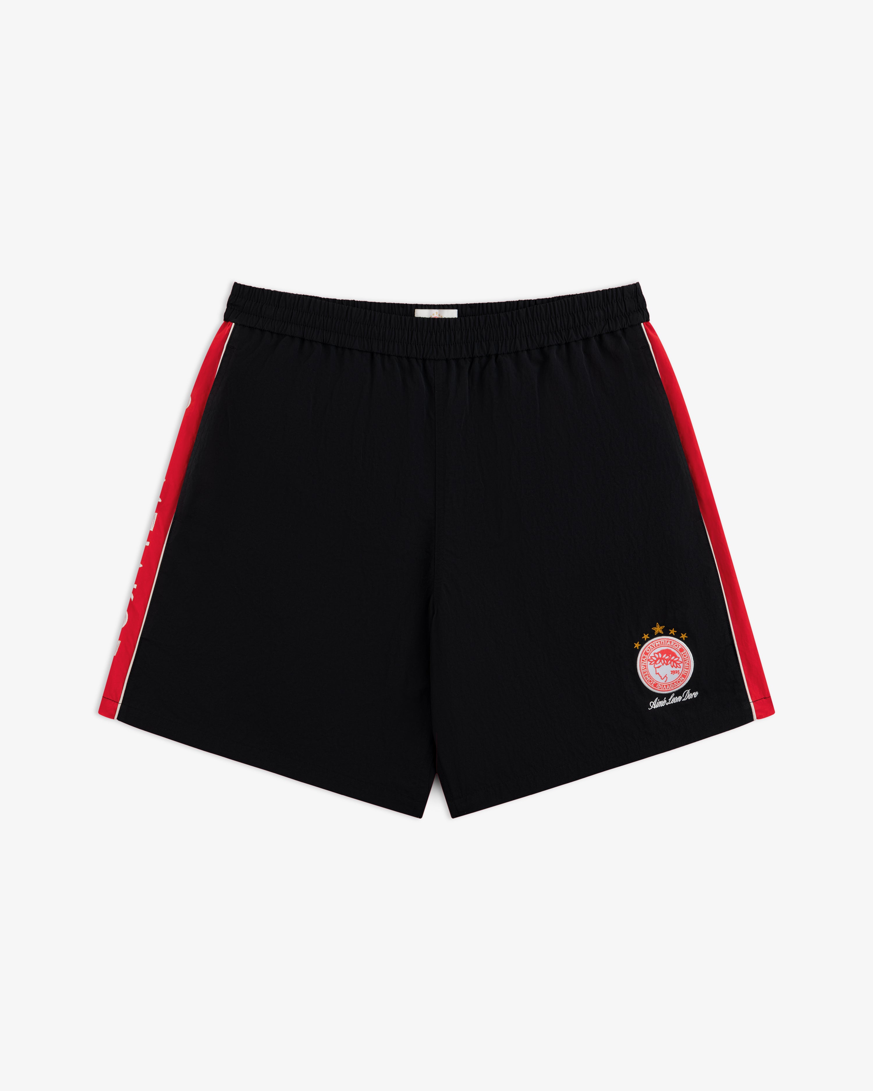 ALD / Olympiacos F.C. Nylon Training Short in black with red side stripes and a circular team crest on the right leg.