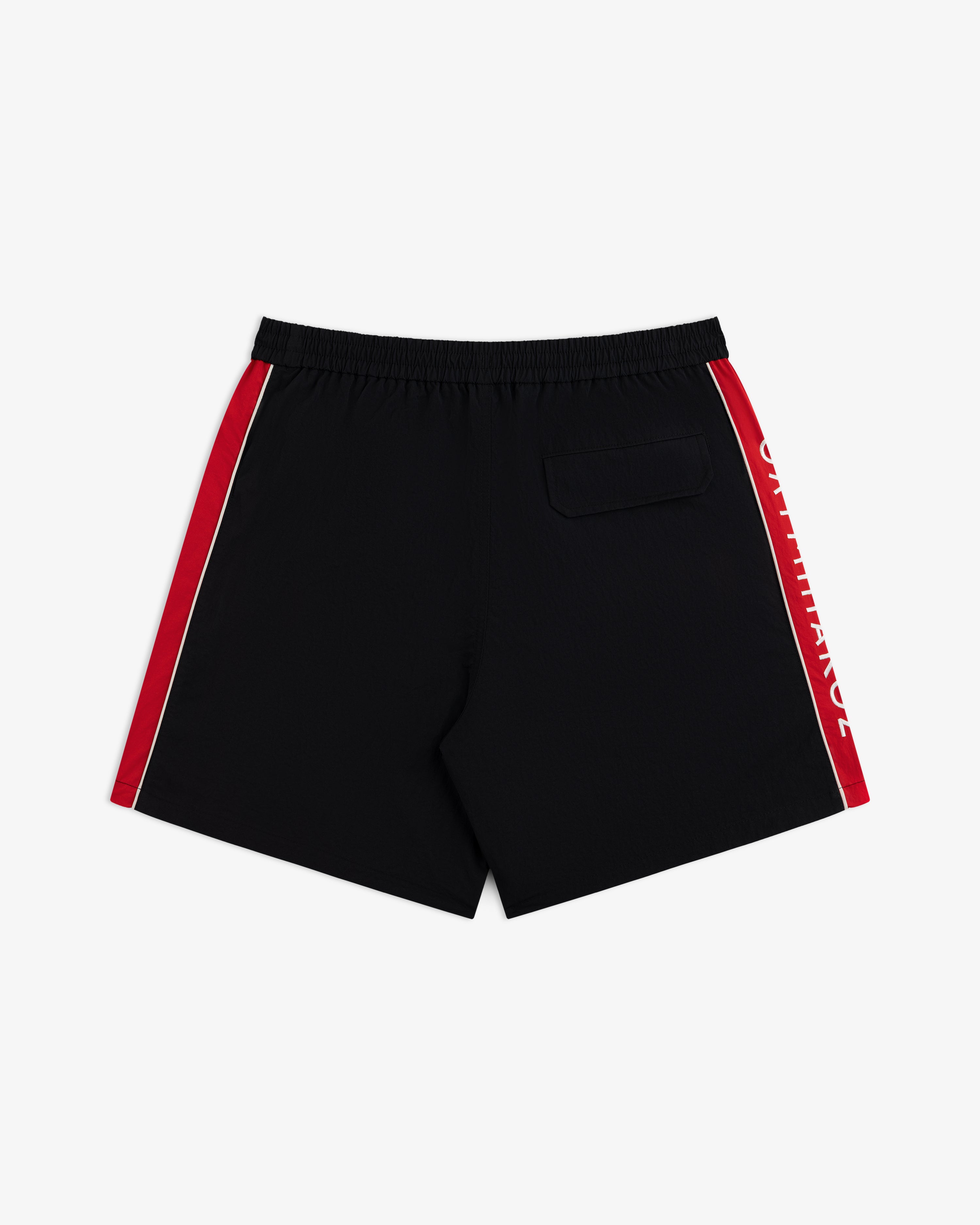 ALD / Olympiacos F.C. Nylon Training Short: black nylon athletic shorts with red side stripes, white lettering, and a pocket.