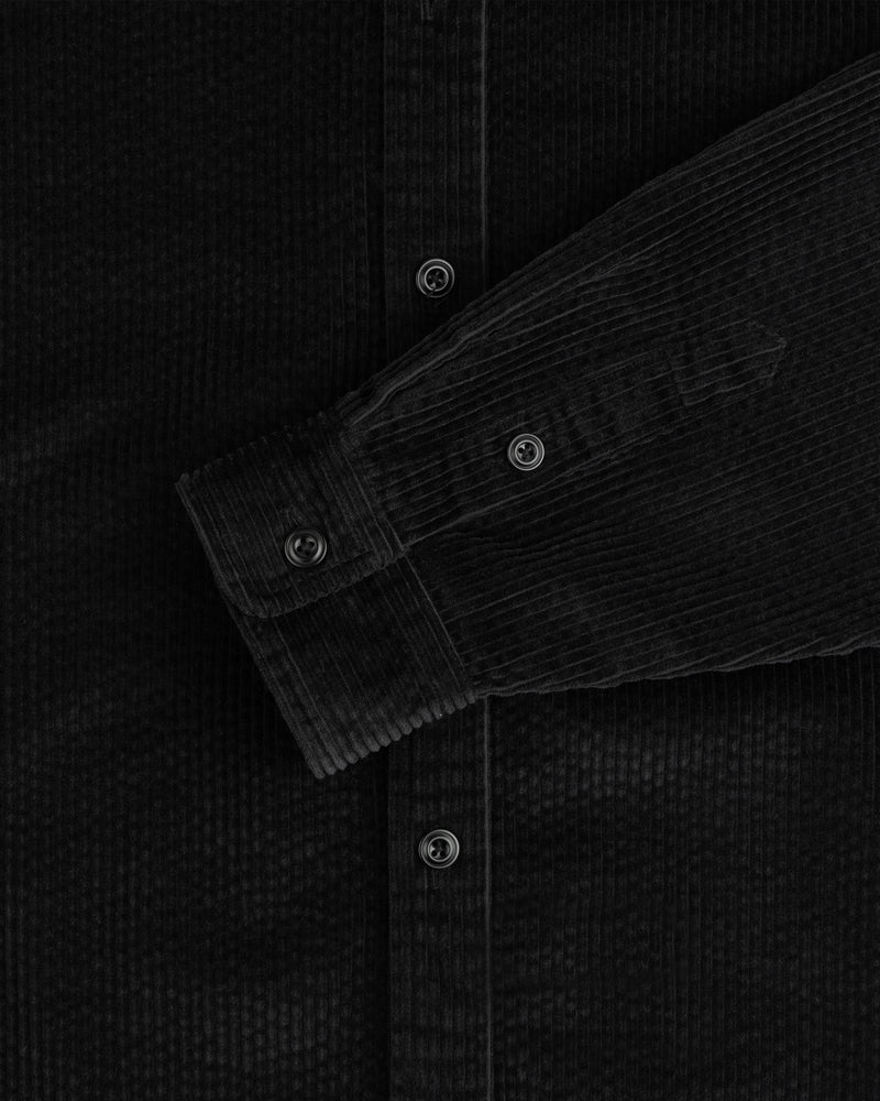 Black Corduroy Leon Overshirt with a buttoned sleeve cuff and front placket.