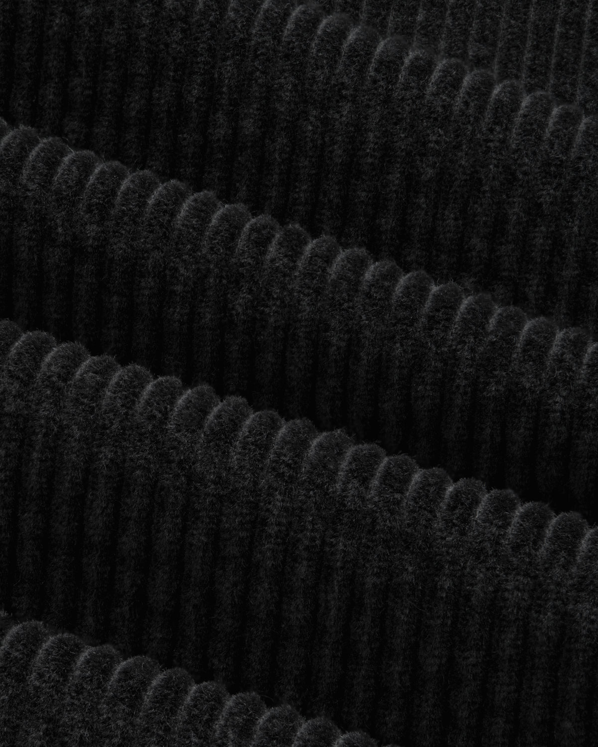 Close-up of the black Corduroy Leon Overshirt featuring fabric with wide, vertical wales.