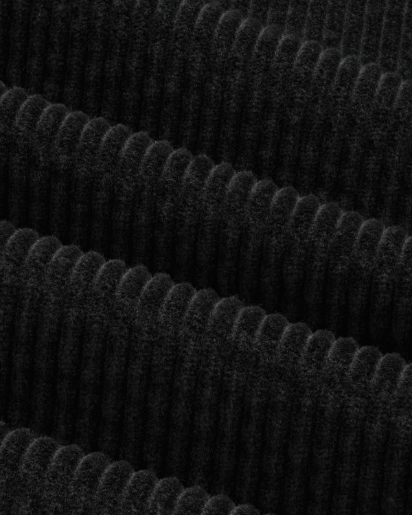 Close-up of the black Corduroy Leon Overshirt featuring fabric with wide, vertical wales.